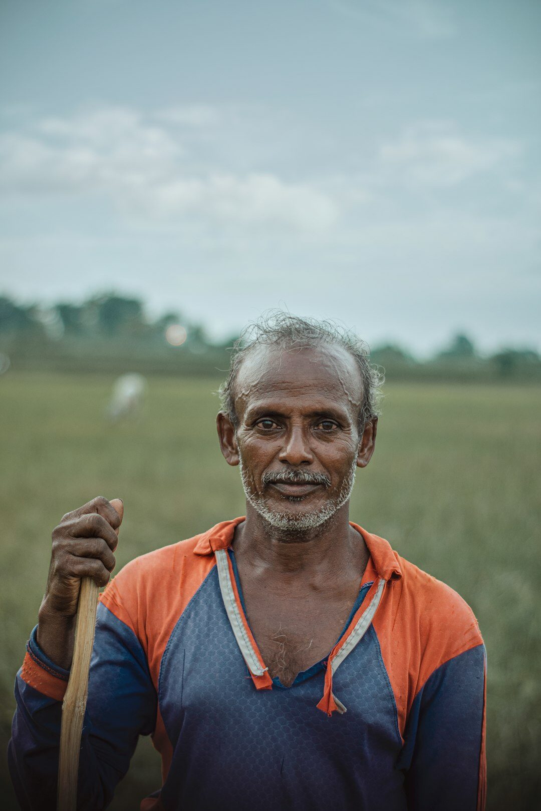 Portrait of a Danish farmer standing in a field