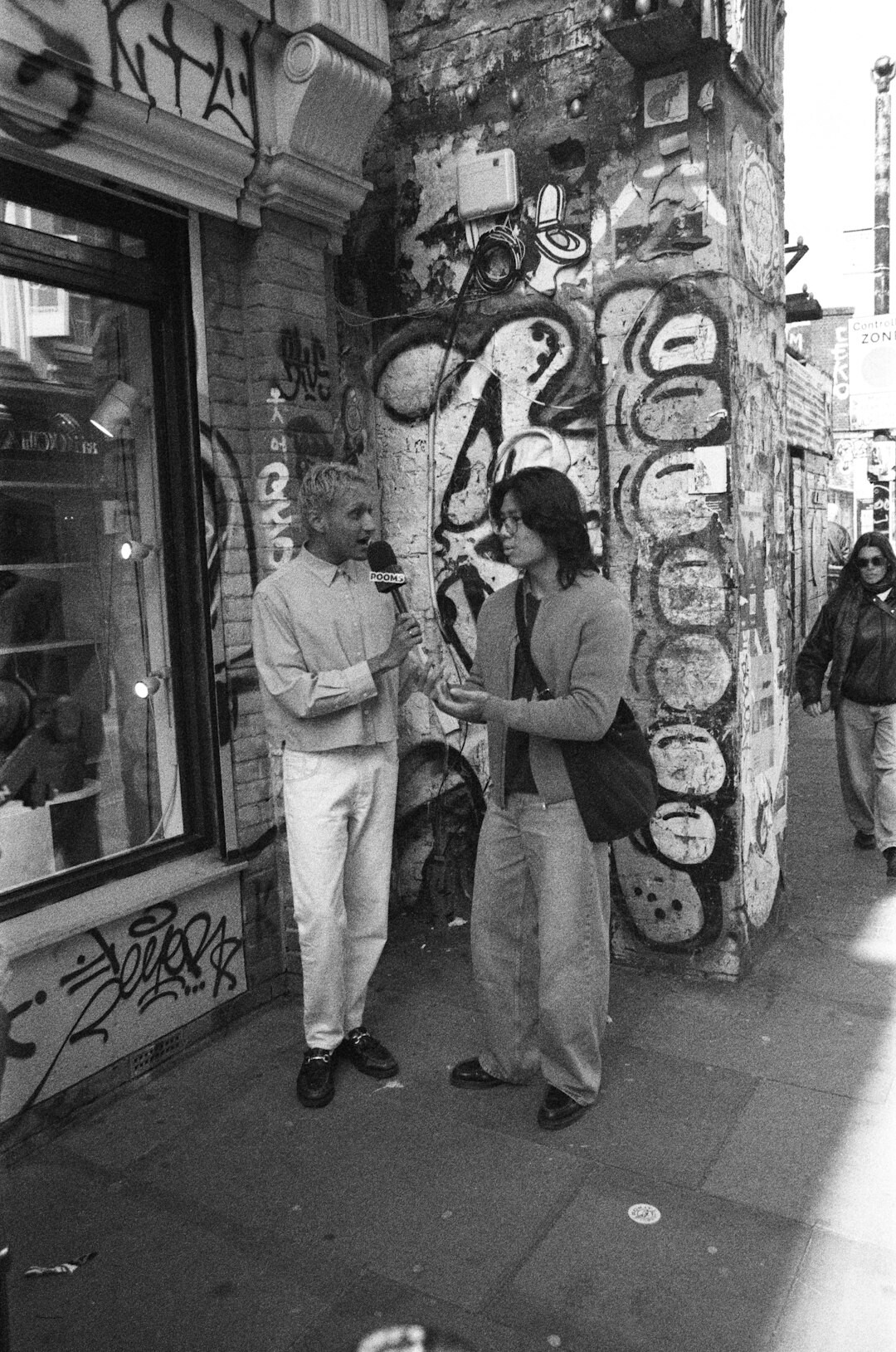 Photographer interviewing a local resident with a notebook and camera